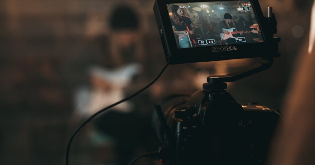 A cinematic close-up of filming a rock band performance with focus on camera screen.